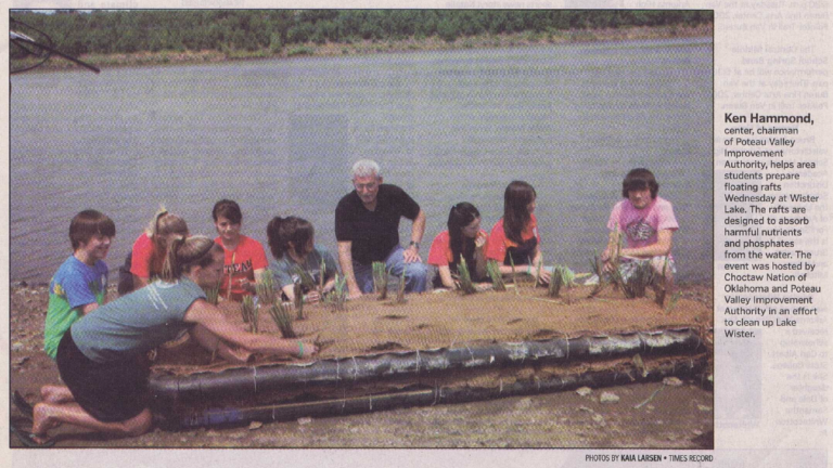 PVIA Chairman Dr. Ken Hammond and local area middle schoolers pose with a newly planted floating wetland at Lake Wister, April 21, 2010