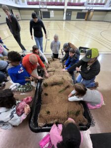 kids planting a constructed floating wetland